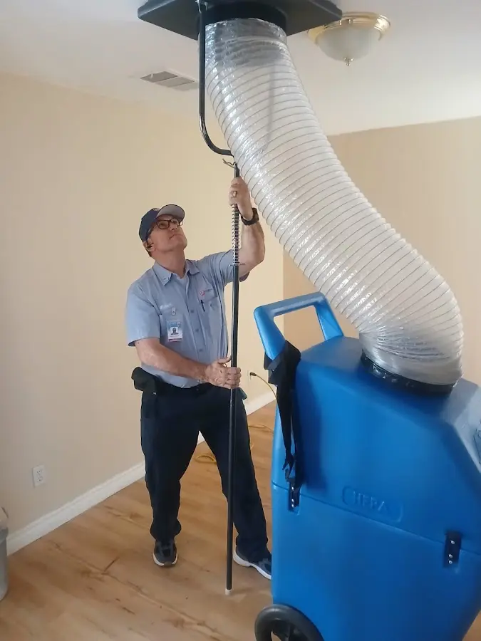 Furnace Tune-Up technician using HEPA equipment in Edwards